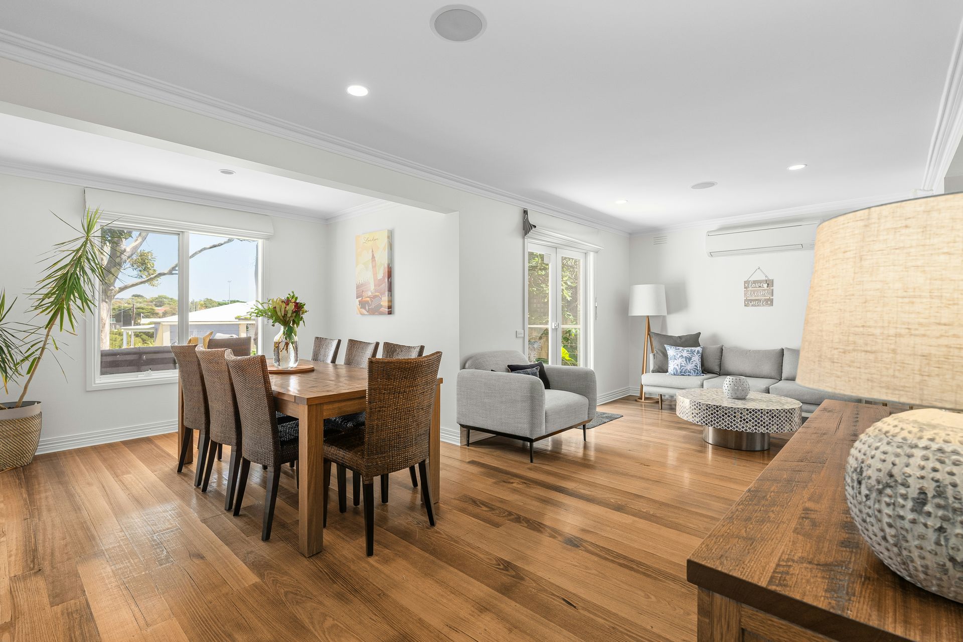 A living room and dining room with hardwood floors