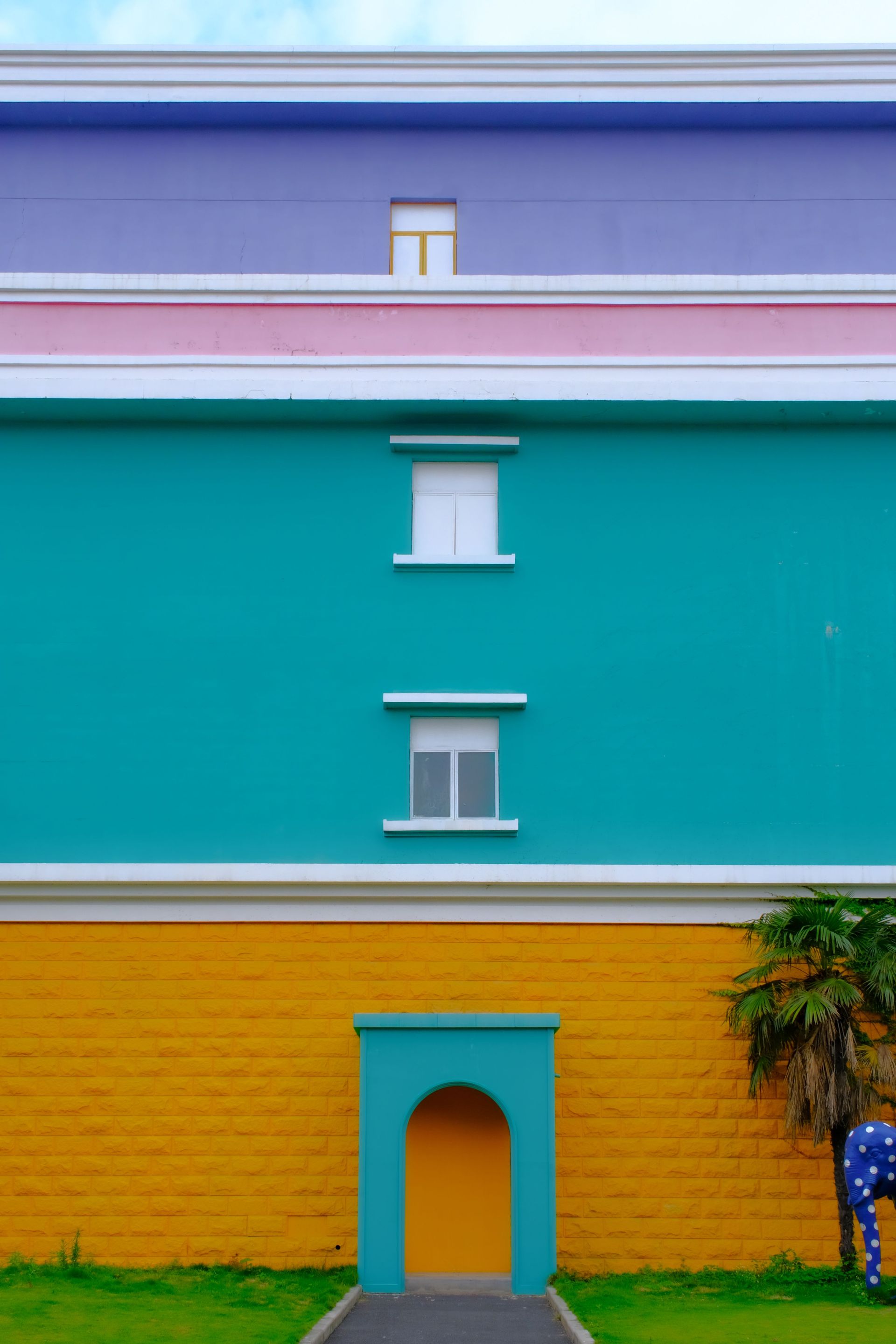 Vibrant multi-colored building facade featuring geometric shapes and distinct color blocks.